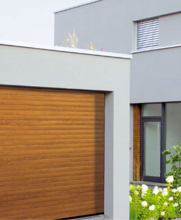 Timber garage door with slotted design installed into a white garage